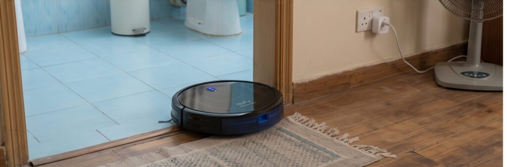 Eufy RoboVac 11S MAX cleaning transition from tiled bathroom to wood floor in 480 sq ft apartment